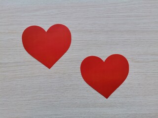 Red heart. Two red hearts. Red heart on wooden background. Valentine's Day.