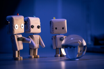 A small wooden toy robots looks at a glass ball in the dark. wallpaper, blured background. low light