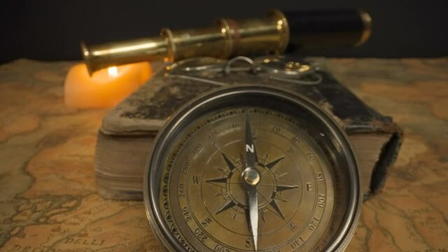 The navigational tools on top of the map on the table with the book glasses compass and the telescope in Estonia