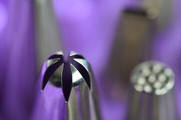 Detail of a group of pipping tips on a purple background