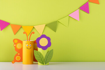 cute paper butterfly made from a toilet paper tube. spring background