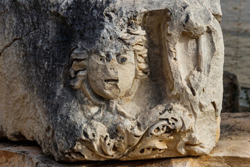 Fototapeta na wymiar Stone faces in the ancient city of Myra in Demre, Antalya province in Turkey
