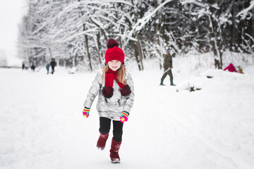 Little happy girl having fun in winter