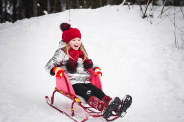 Little happy girl having fun in winter