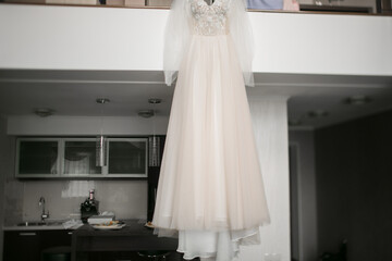 Fototapeta na wymiar The wedding dress is hanging in the house.