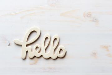 word hello on white wood background