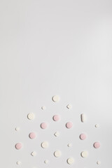 Pink pills on white background, direction