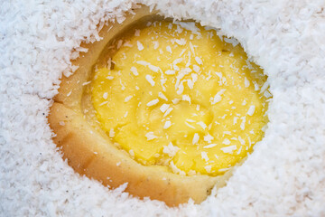 Sweet bun with cheese and coconut flakes.