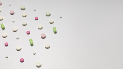 Multicolored pills on white background, pattern