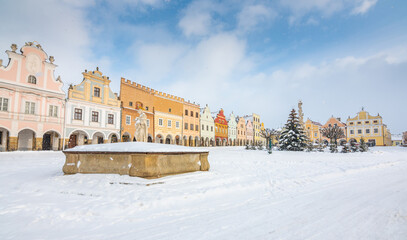 Main square of Telc with its famous 16th-century colorful houses, a UNESCO World Heritage Site since 1992, on a winter day with falling snow.