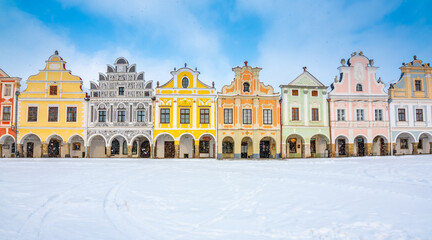 Fototapeta na wymiar Main square of Telc with its famous 16th-century colorful houses, a UNESCO World Heritage Site since 1992, on a winter day with falling snow.