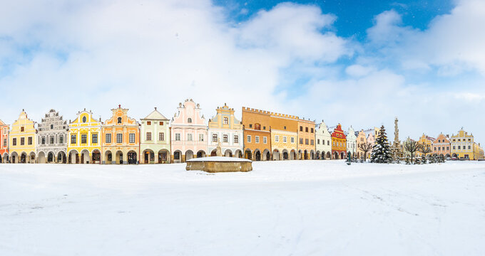Main square of Telc with its famous 16th-century colorful houses, a UNESCO World Heritage Site since 1992, on a winter day with falling snow.