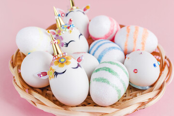 Unicorn eggs in the box isolated on pink background. Happy easter. Kids activity.