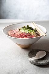 Japanese ramen. Asian soup with noodles ramen, miso, fried tuna steak and seaweed algae