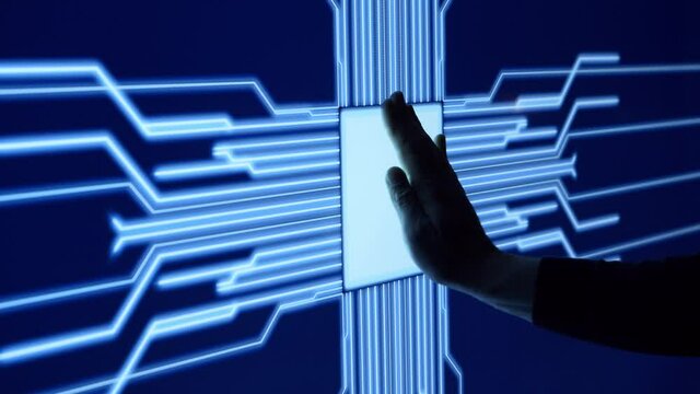 Human arm is pressing a digital button on a glowing touchscreen. Futuristic microprocessor is starting the operation of the computer program. Machine learning and artificial intelligence.
