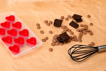 Obraz na płótnie Canvas Handmade valentines day dessert. DIY Making chocolate candy, heart shaped mold. Chocolatier sweet shop business concept