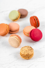 Colorful Fruity Macarons Flat Lay and Top View on White Marble Table