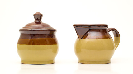 Ceramic sugar bowl or pot and creamer set on white