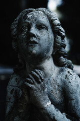 Figure of praying angel. Ancient destroyed statue.