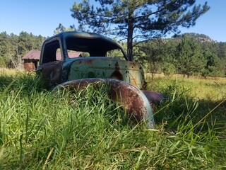 Rusty car in a field