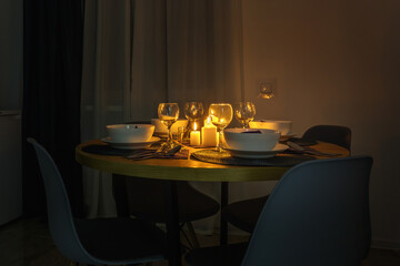served table with cutlery and candles in interior of modern luxure guest room in studio apartments.  intimate atmosphere