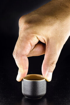 Hand Holding Oriental Ceramic Cup, For Serving Sake Drink. Japanese Traditional Drink