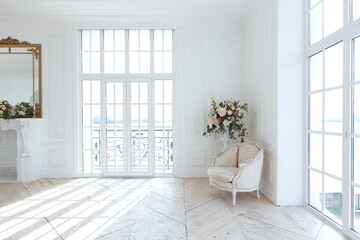 chic white huge spacious hall with a minimum of expensive antique furniture. Baroque interior...