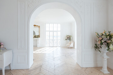 chic white huge spacious hall with a minimum of expensive antique furniture. Baroque interior...