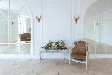 chic white huge spacious hall with a minimum of expensive antique furniture. Baroque interior...