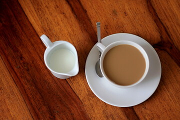 cup of coffee with milk  on a table with white background stock photo