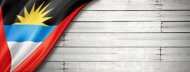 Antigua and Barbuda flag on old white wall banner