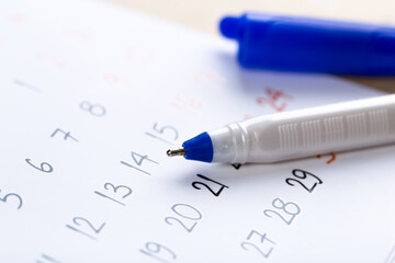 Fototapeta premium white calendar page for 2021 month schedule to make an appointment or manage the schedule every day with ballpoint pen for marks