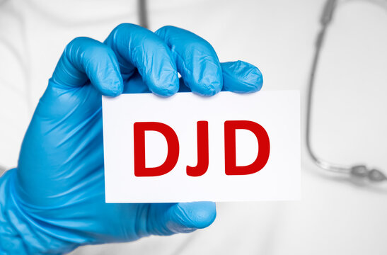 Doctor holding a card with text DJD Degenerative joint disease, medical concept