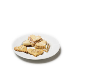 Heart-shaped cookies on a white plate. Background for Valentine's Day.