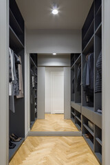 Spacious walk in closet with mirror wall
