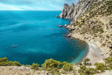 
blue sea with high mountains