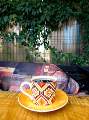 Fresh coffee in orange coffee cup on the table. 