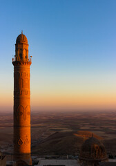Minaret of historical Great Mosque, Ulu Cami, in Mardin, Turkey during the sunset. Panoramic view...