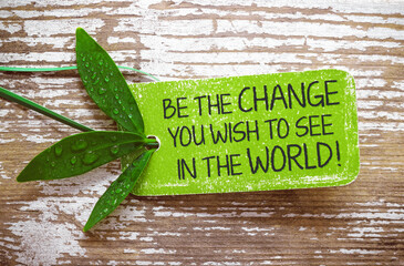 Be the change you wish to see in the world! motivation text on nature label