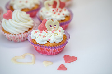 Homemade muffins for Valentine's Day. Photo 6: The finished dessert is decorated with cream and hearts.