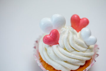 Homemade muffins for Valentine's Day. Photo 6: The finished dessert is decorated with cream and hearts.