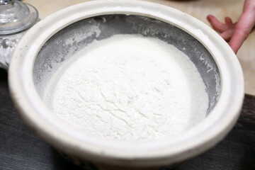 Bowl with flour on table