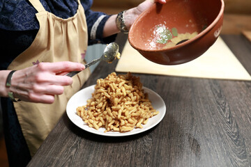 Chef puts chak-chak on plate