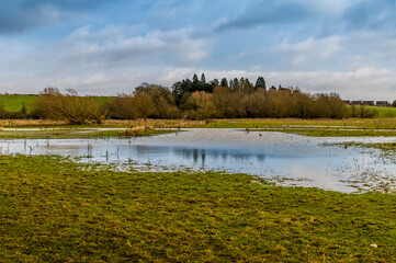 A view across the River Welland flood water looking towards Market Harborough, UK in winter
