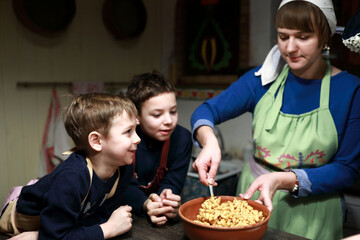 Woman stirring pieces of fried dough with melted honey