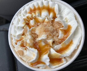 top view of latte with whipped cream and toffee