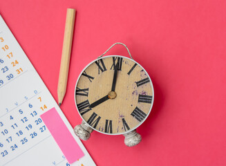 Fototapeta na wymiar Close-Up Of Calendar With Alarm Clock 