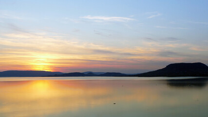 Sunset by lake Balaton in Hungary with volcanic hill Badacsony 