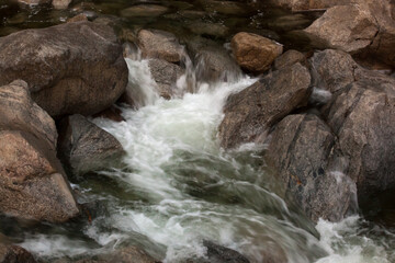 Cascading stream outdoors in the rocks of nature