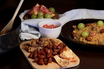 Food spanish crumbs with sausages, bacon, pomegranate and grapes